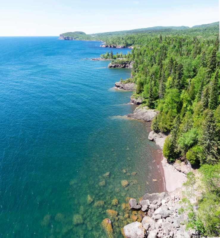 Beautiful aerial photo of lake superior and the surrounding trees.