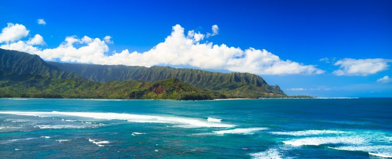 Beautiful daytime photo of Hanalei Bay with its mountains in the backdrop.