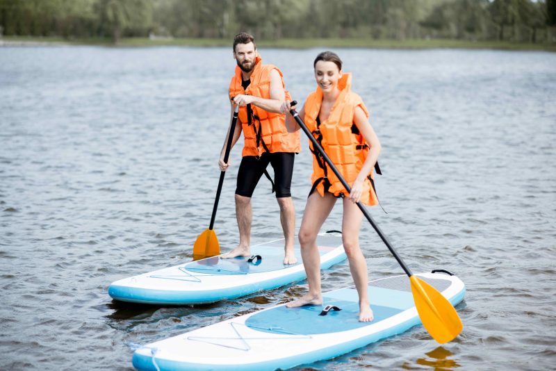 Couple Standing on Paddle Boards.