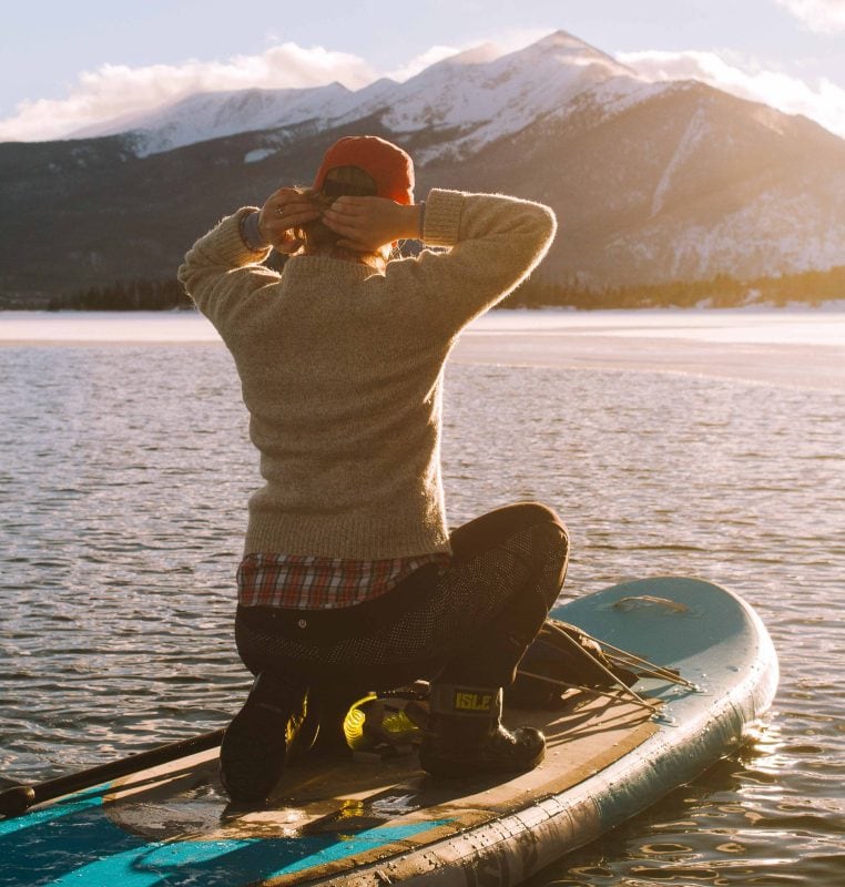 Paddle Boarder in the cold nearby pretty mountains